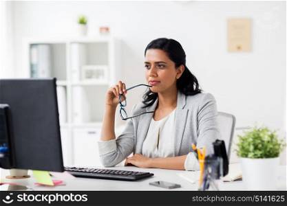 business, people, work and technology concept - businesswoman with glasses and computer at office. businesswoman with glasses and computer at office