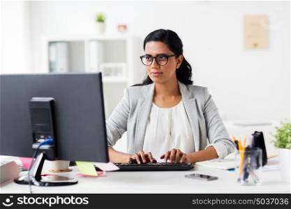 business, people, work and technology concept - happy businesswoman with computer at office. happy businesswoman with computer at office