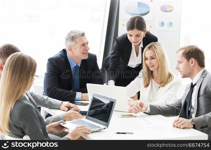 Business people work with laptop. Business people work with laptop and financial statistics in office