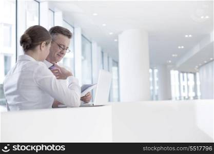 Business people working at railing in office