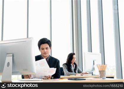 Business people working at table in modern office room while analyzing financial data report .
