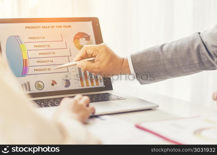 Business people working on laptop computer in office