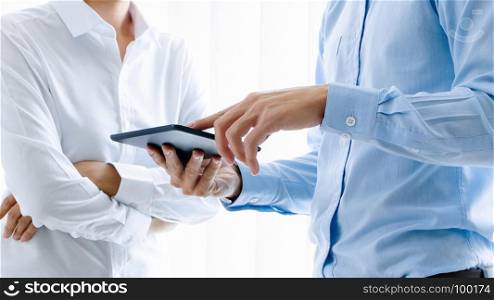 Business people working together and using digital tablet at a workplace