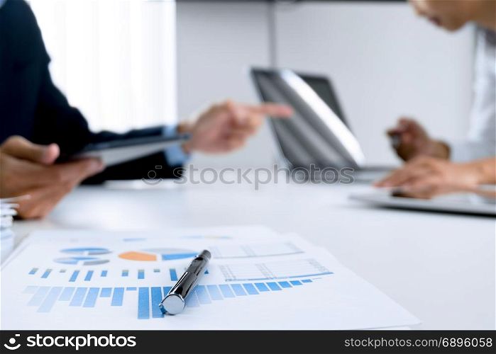 Business people working together and using digital tablet at a workplace, selective focus