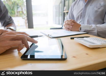 Business people working together and using tablet at a modern office