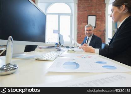 Business people working together. Two business people working together in the office with statistics