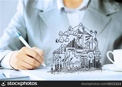 Business person at work. Image of businesswoman sitting at table and drawing sketch