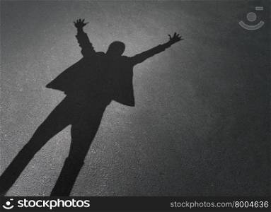 Business person corporate success as a cast shadow of a successful businessman celebrating with arms up in the air on a pavement background as a winning entrepreneur.