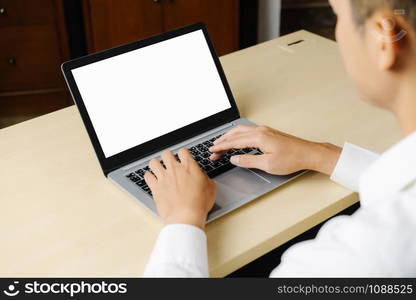 Business person or office worker using laptop computer while sitting at desk.