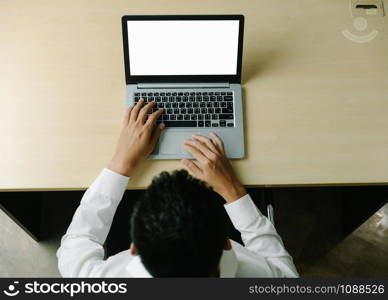 Business person or office worker using laptop computer while sitting at desk.