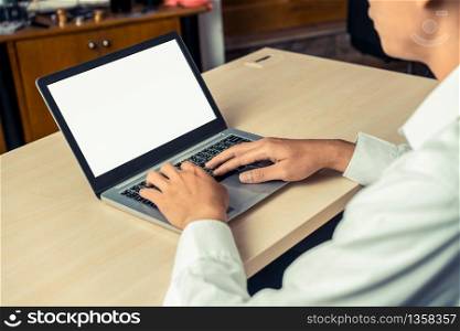Business person or office worker using laptop computer while sitting at desk.