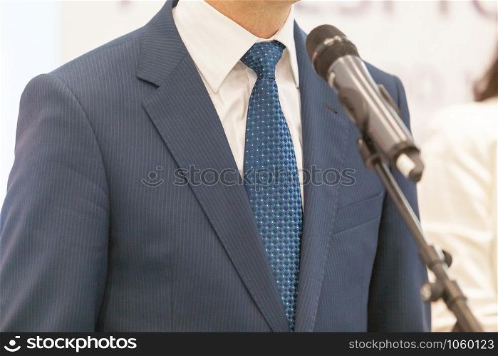 Business person or politician is giving a speech at media event