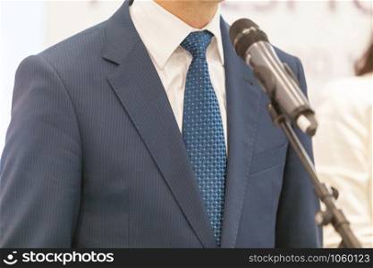 Business person or politician is giving a speech at media event