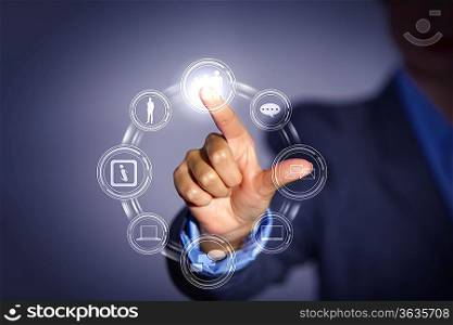 Business person pushing symbols on a touch screen interface
