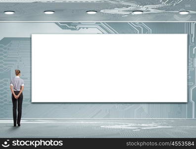 Business person standing near a blank billboard. Business person standing near a white blank billboard