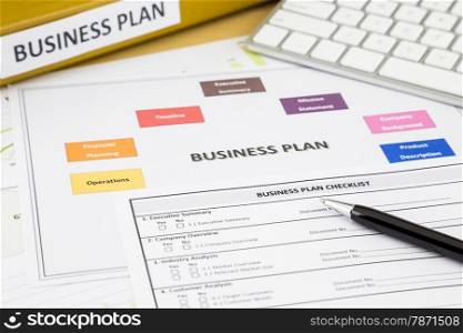 Business plan checklist and paperwork place on office table