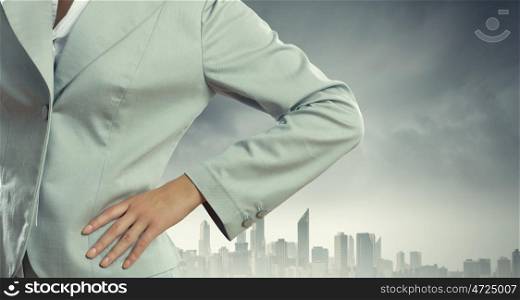 Business plan. Close up of confident businesswoman against city background