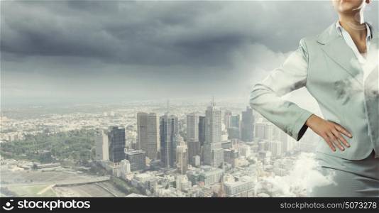 Business plan. Close up of confident businesswoman against city background