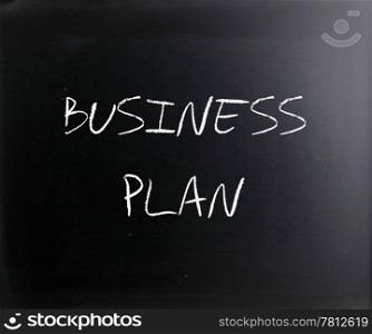 ""Business plan" handwritten with white chalk on a blackboard."