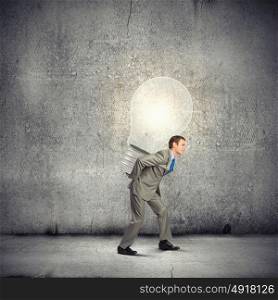 Business plan. Image of businessman carrying bulb on back. New idea