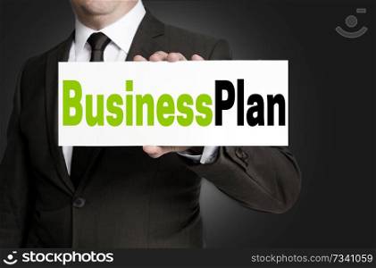 Business Plan sign is held by businessman concept.. Business Plan sign is held by businessman concept