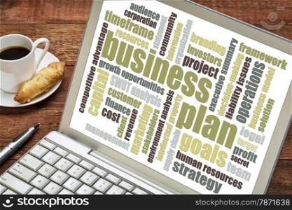 business plan word cloud on laptop with cup of coffee