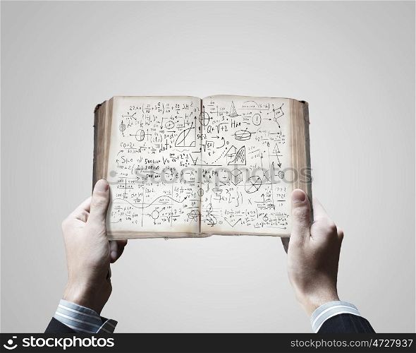 Business planning. Close up of businessman hands holding opened notepad with sketches