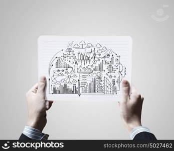 Business planning. Close up of businessman hands holding opened notepad with sketches