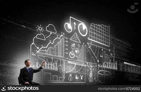 Business planning ideas. Businessman writing with marker strategy sketches on screen