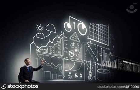 Business planning ideas. Businessman writing with marker strategy sketches on screen