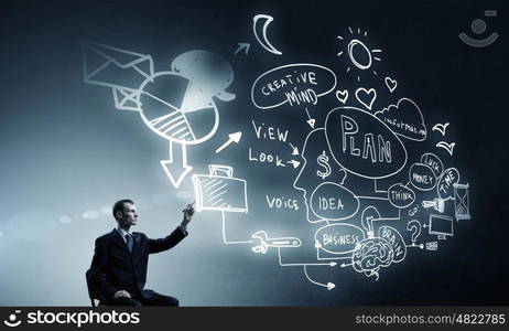 Business planning ideas. Businessman writing with marker strategy sketches on screen