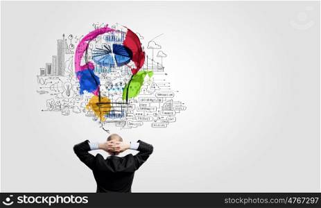 Business planning. Rear view of businessman looking at business ideas