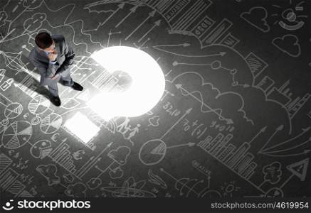 Business planning. Top view of businessman looking at business sketches on floor