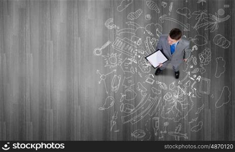 Business planning. Top view of businessman looking at business sketches on floor