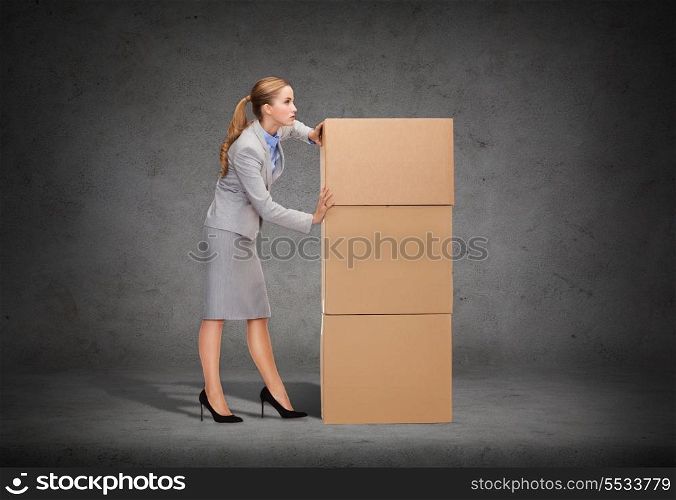 business, post and transportation concept - busy businesswoman pushing tower of cardboards