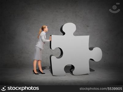 business, post and transportation concept - smiling businesswoman pushing big puzzle piece