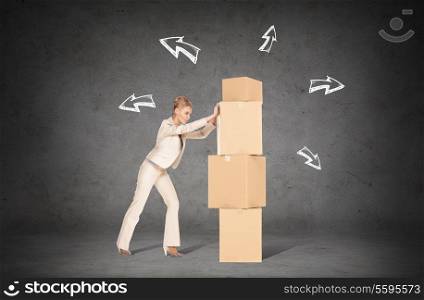 business, postal and office concept - businesswoman pushing tower of cardboard boxes with direction arrows