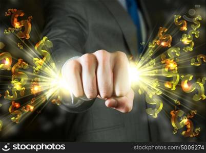Business power. Close up of businessman grasping dollar signs in fist