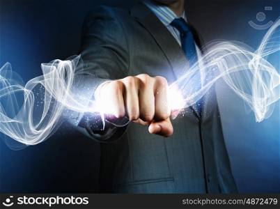 Business power. Close up of businessman grasping something in fist