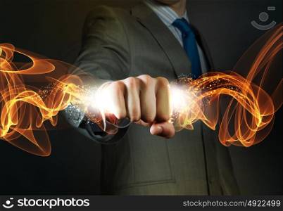 Business power. Close up of businessman grasping something in fist