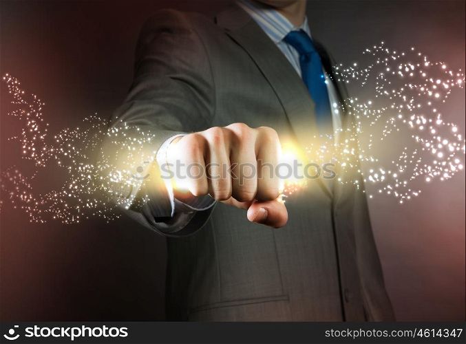 Business power. Close up of businessman grasping star dust in fist