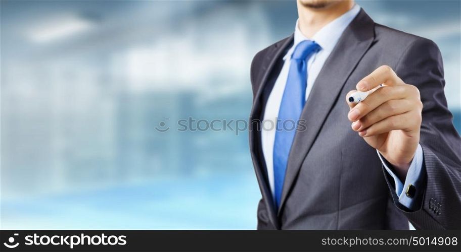 Business presentation. Close up of businessman drawing with marker on screen