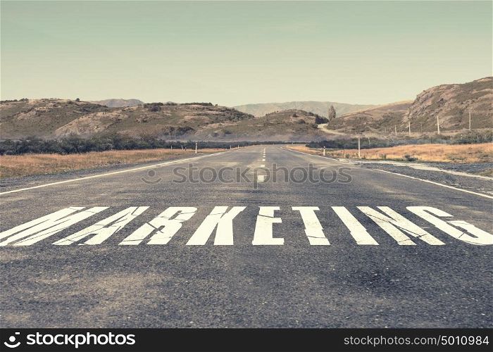 Business process management. Asphalt road with word marketing as business motivation