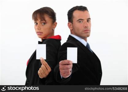 Business professionals holding their business cards