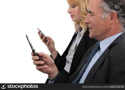 Business professionals sending text messages