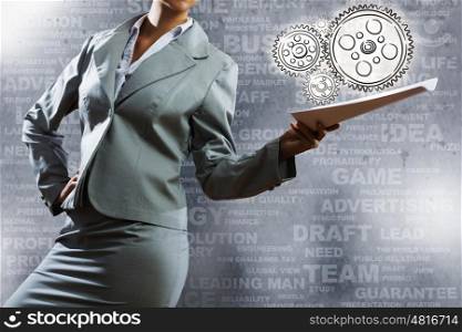 Business project. Businesswoman holding papers in hand and business sketches at background