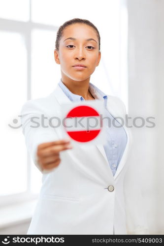 business, protest, racism concept - african woman showing stop sign