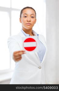 business, protest, racism concept - african woman showing stop sign