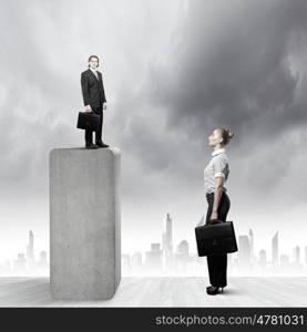 Business relations. Businessman standing on top and looking down at colleague