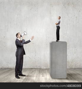 Business relations. Businesswoman standing on top and looking down at colleague